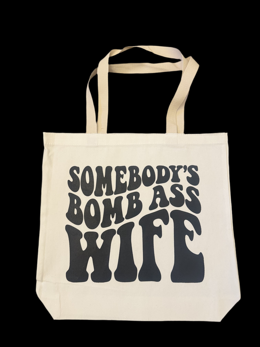 Somebody’s bomb ass wife tote bag