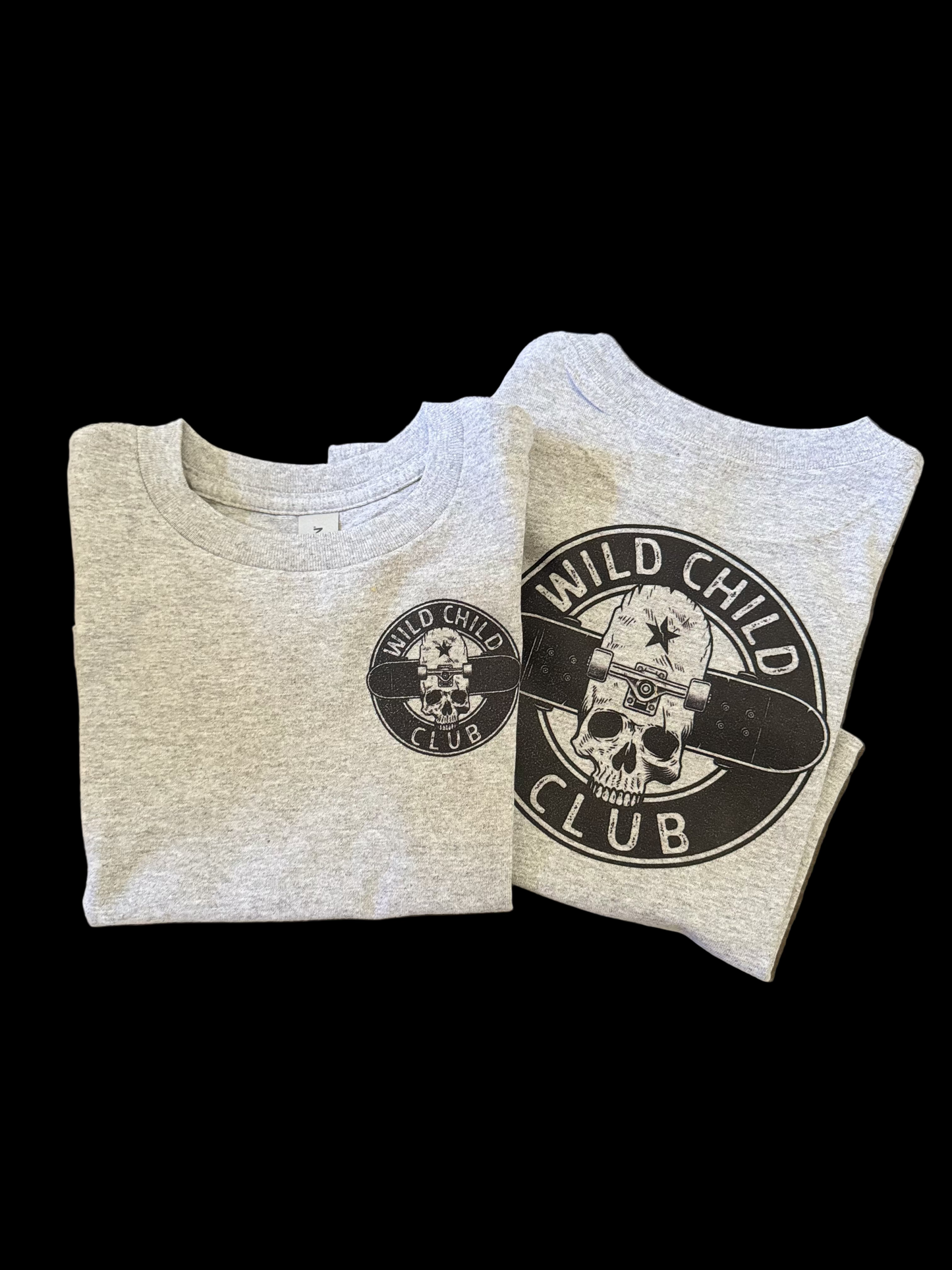  light grey t-shirts, one with a skateboard and death symbol graphic and the other with a plain skull and crossbones logo, both with 'Wild Child Club' text.